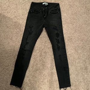 Distressed black skinny jeans
